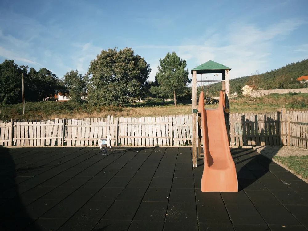 The outdoor slide and wooden deck with hills beyond